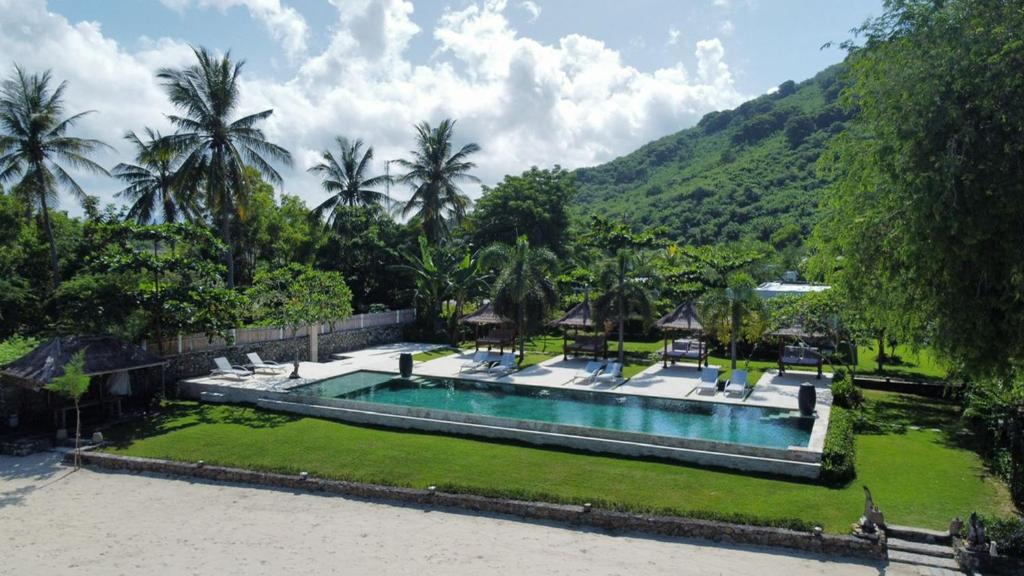Outdoor pool with mountain view at The Suites Lombok