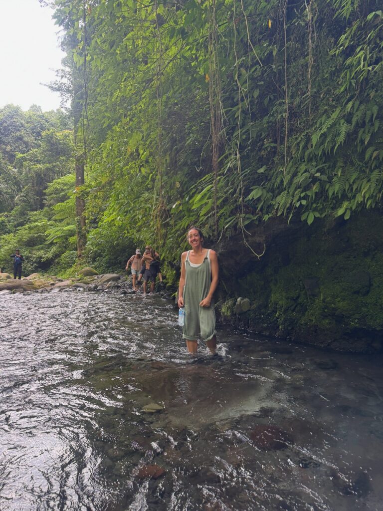 Haylea walking through water on the way to Tiu Kelep Waterfall