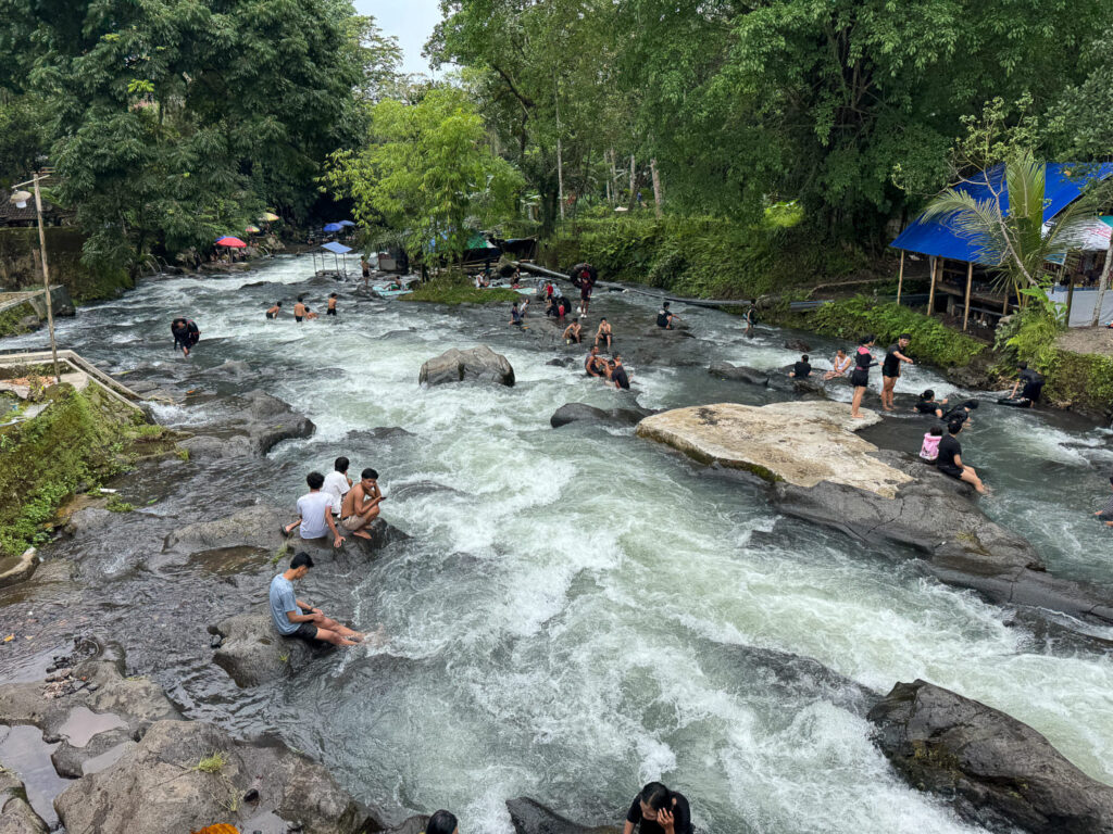 Lombok River tubing: How to Visit Bawak Goak Sesaot 13 People swimming and relaxing beside Bawak Goak Sesaot on a Saturday