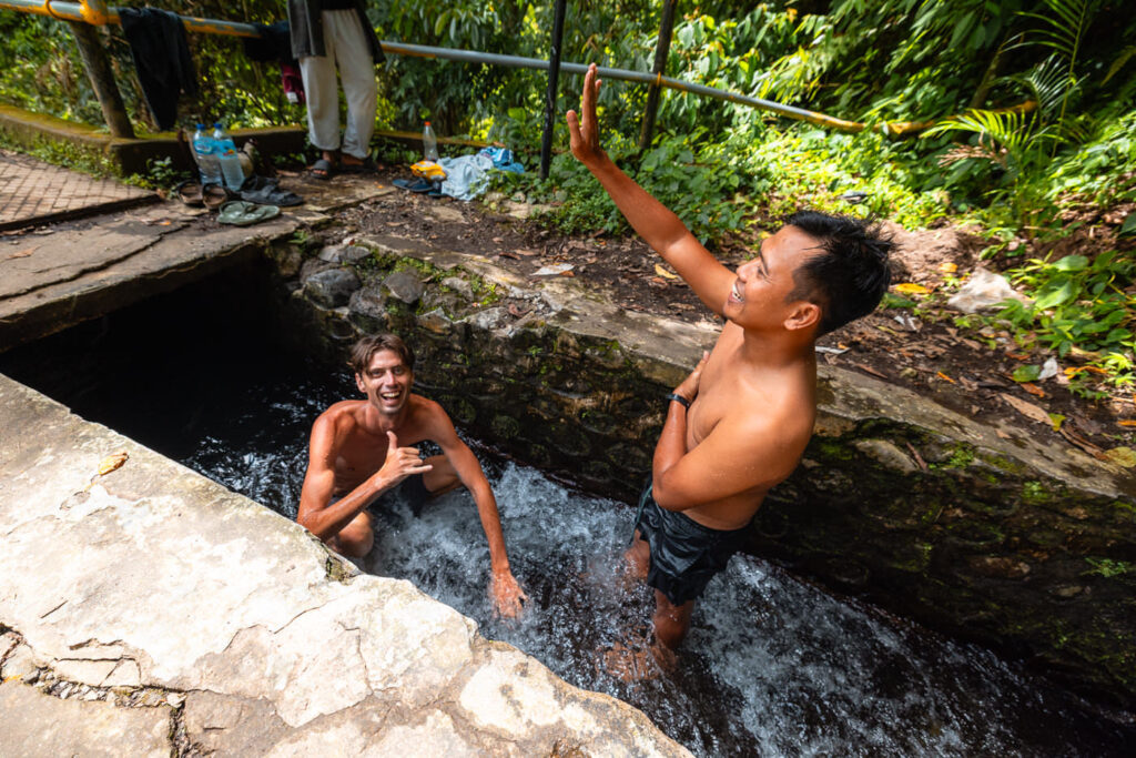 Traveler and guide doing tubing at Tiu Kelep bridge