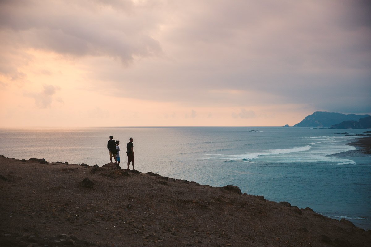 Grassy hills of Bukit Merese dropping into the sea near Tanjung Aan at sunset in south Lombok