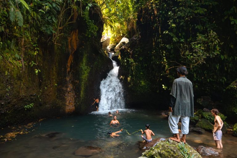 Swimmers in the pool below Durian Indah waterfall, the main Tetebatu waterfall in Lombok