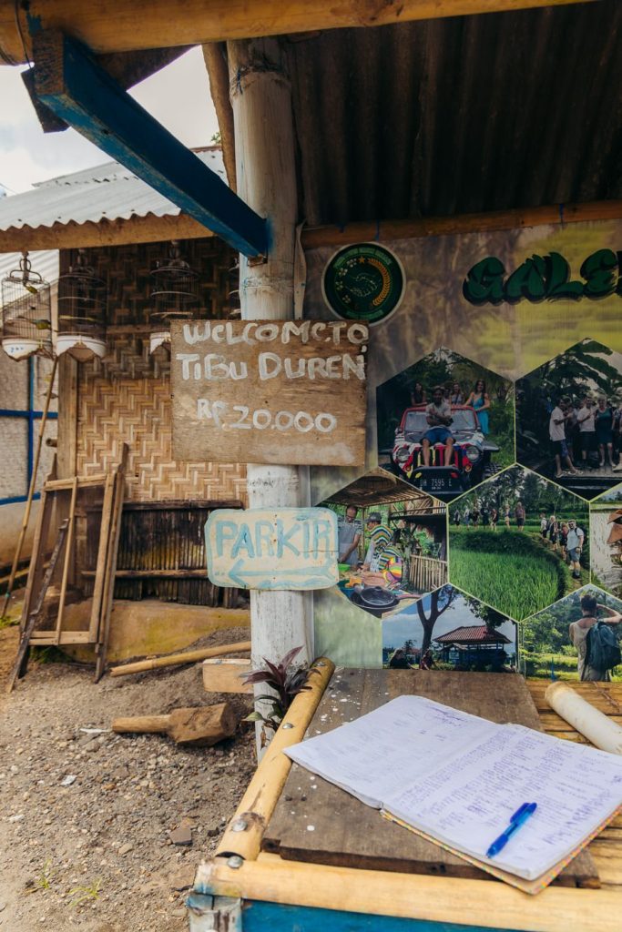 Tetebatu Waterfall (Durian Indah): A Local's Guide 10 Hand-painted Tibu Duren sign at the entrance to Tetebatu waterfall showing the 20,000 IDR entry fee